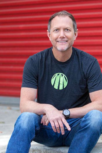 Author, Dale Wannen sitting on the sidewalk